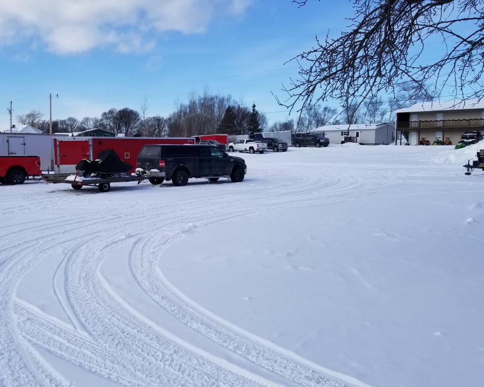 Array of trucks and trailers parked in front of the Voyageurs Motel